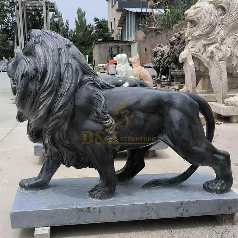 Pair of life size black marble roaring lion statues for sale