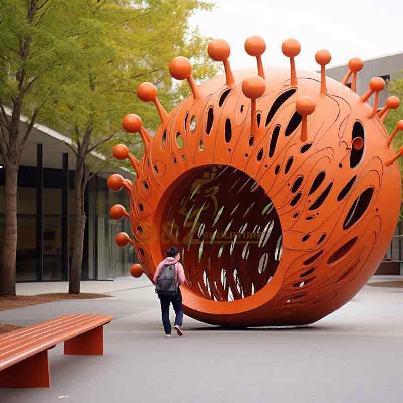 A large orange metal coronavirus sculpture, Virus Sculpture