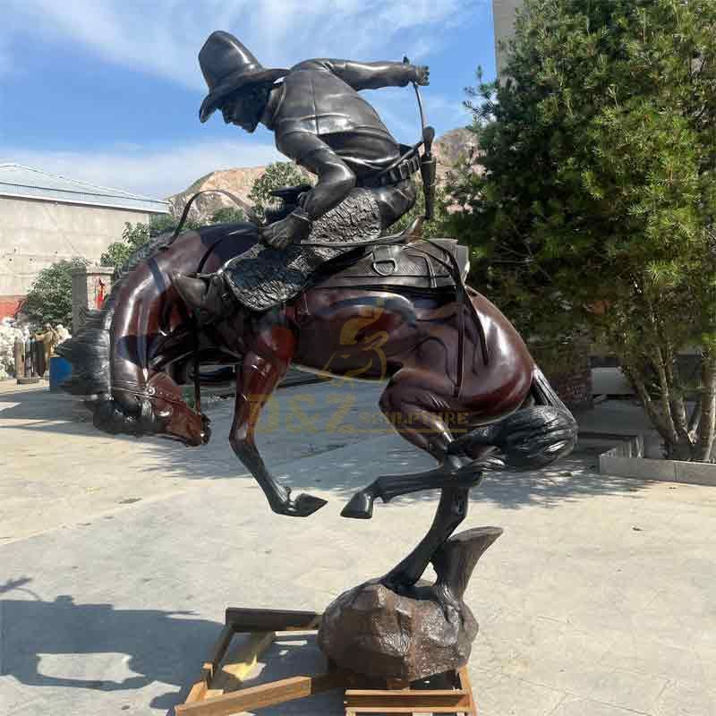 large bronze cowboy on horse statue
