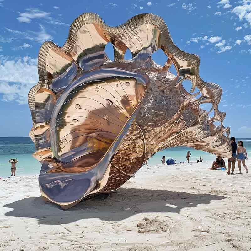 Large abstract metal conch shell sculpture on beach DZ-490