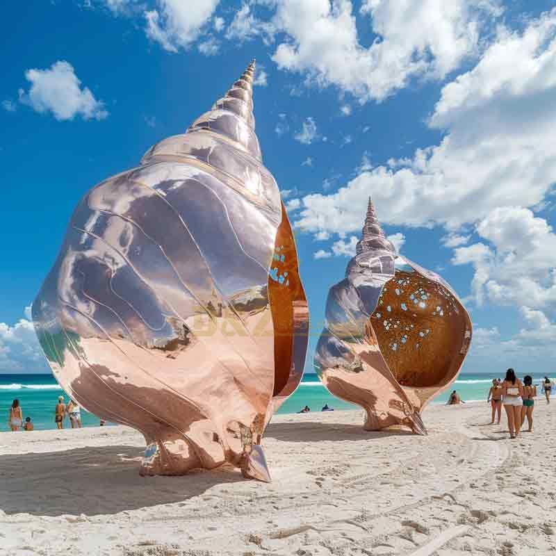 Large abstract metal conch shell sculpture on beach DZ-490