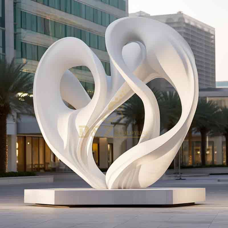 Large white marble abstract city sculpture in front of the office building