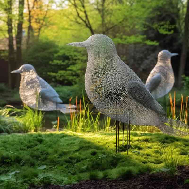 Metal wire bird sculpture in an outdoor garden