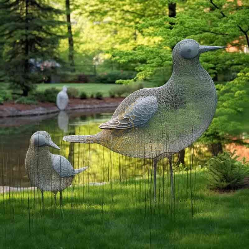 Bird flock sculpture by the lake