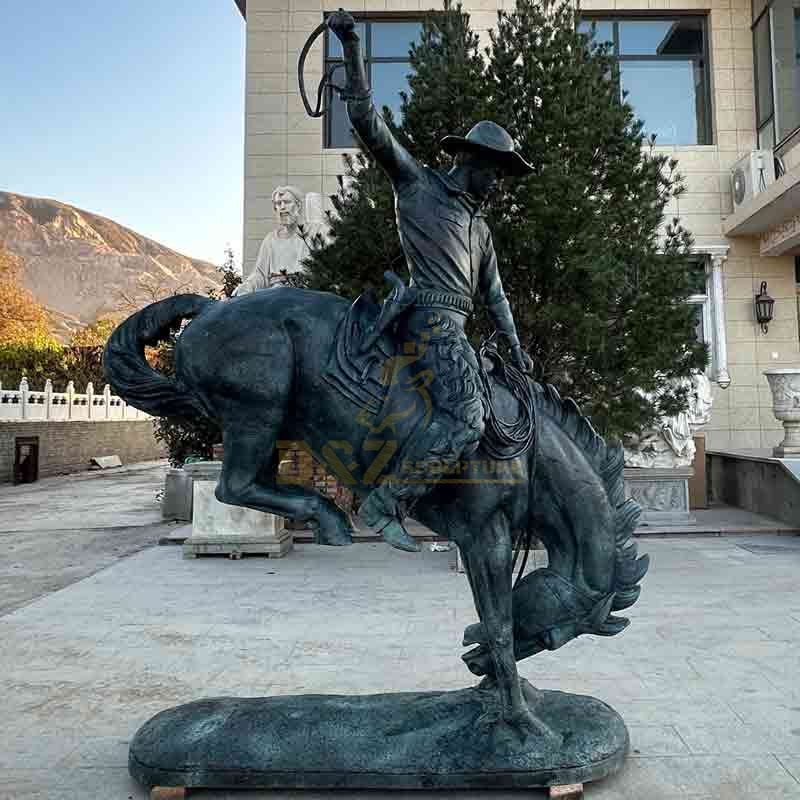 bronze cowboy on horse statue