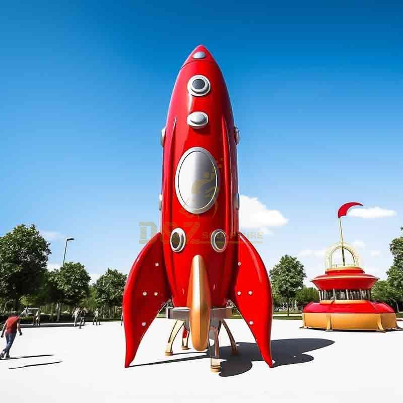 red cartoon metal rocket sculpture