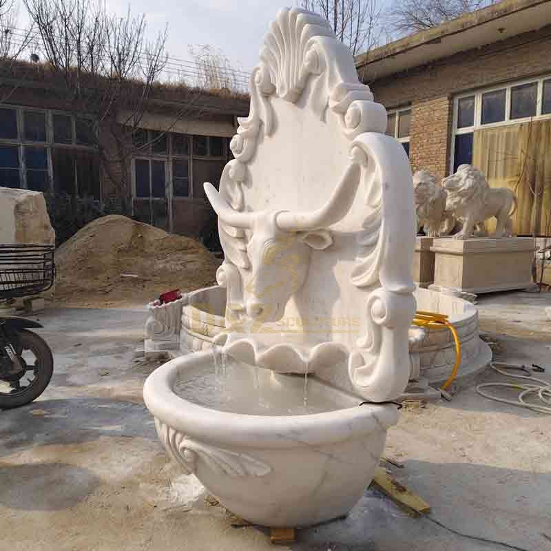 large marble wall fountain with bull statue