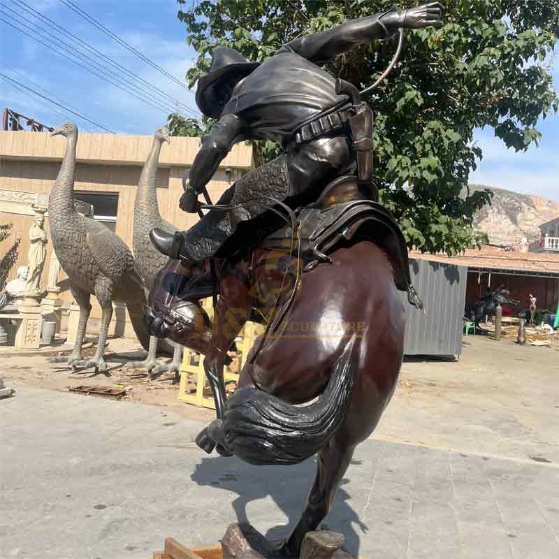 large bronze cowboy on horse statue