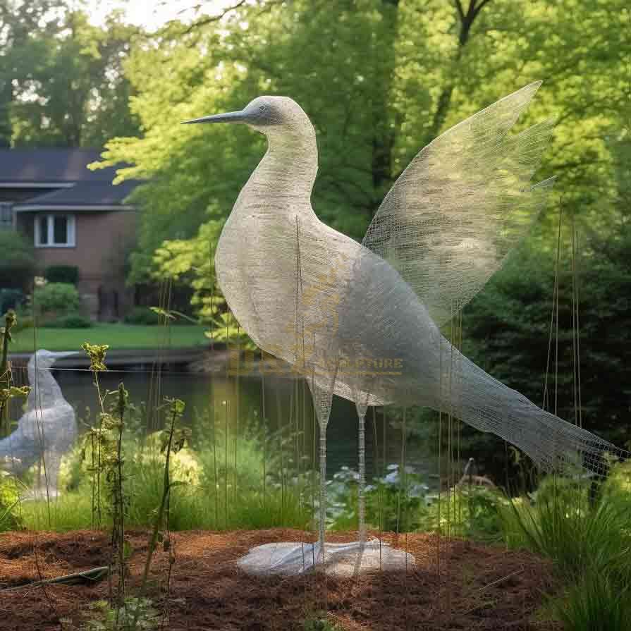 Stainless steel wire abstract bird sculpture by the lake in a private garden