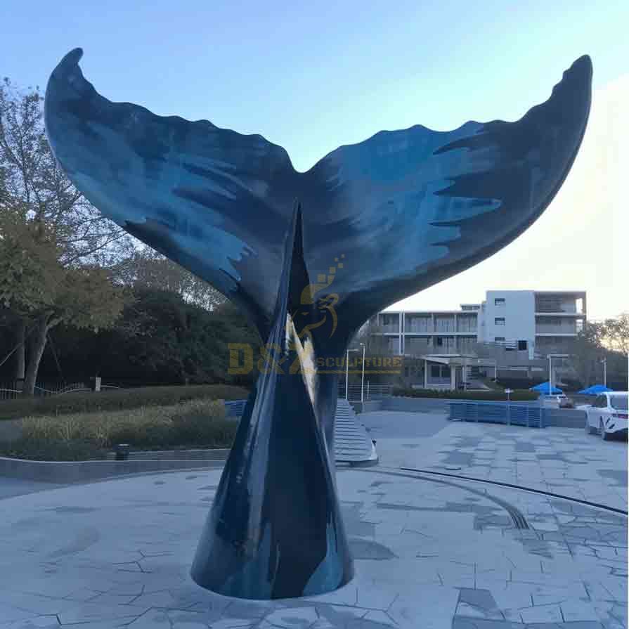 Large metal blue whale tail sculpture in outdoor plaza DZ-618