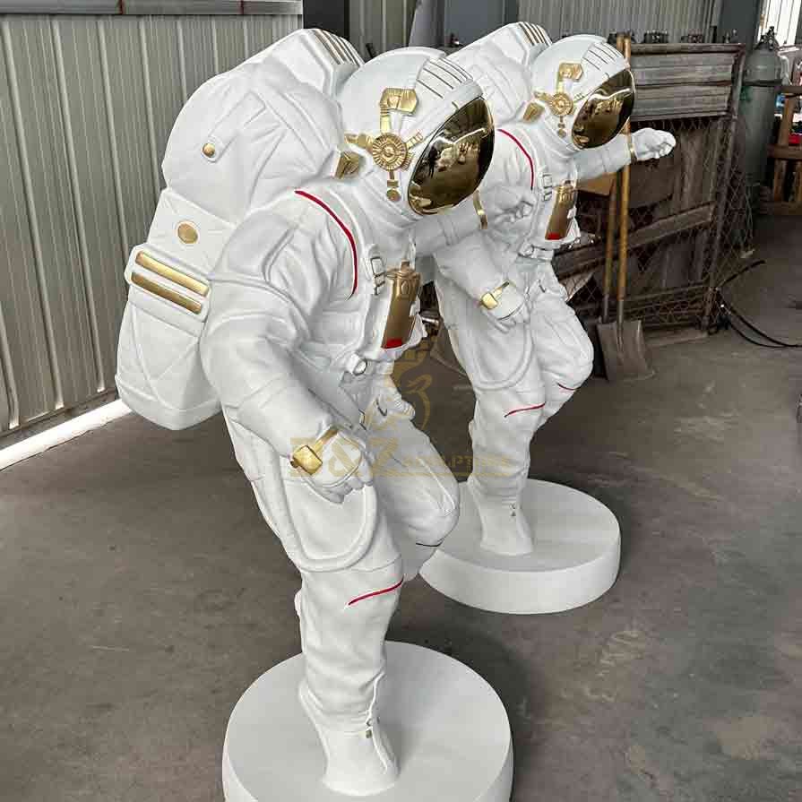 Pair of life-size astronaut statues & sculptures side view