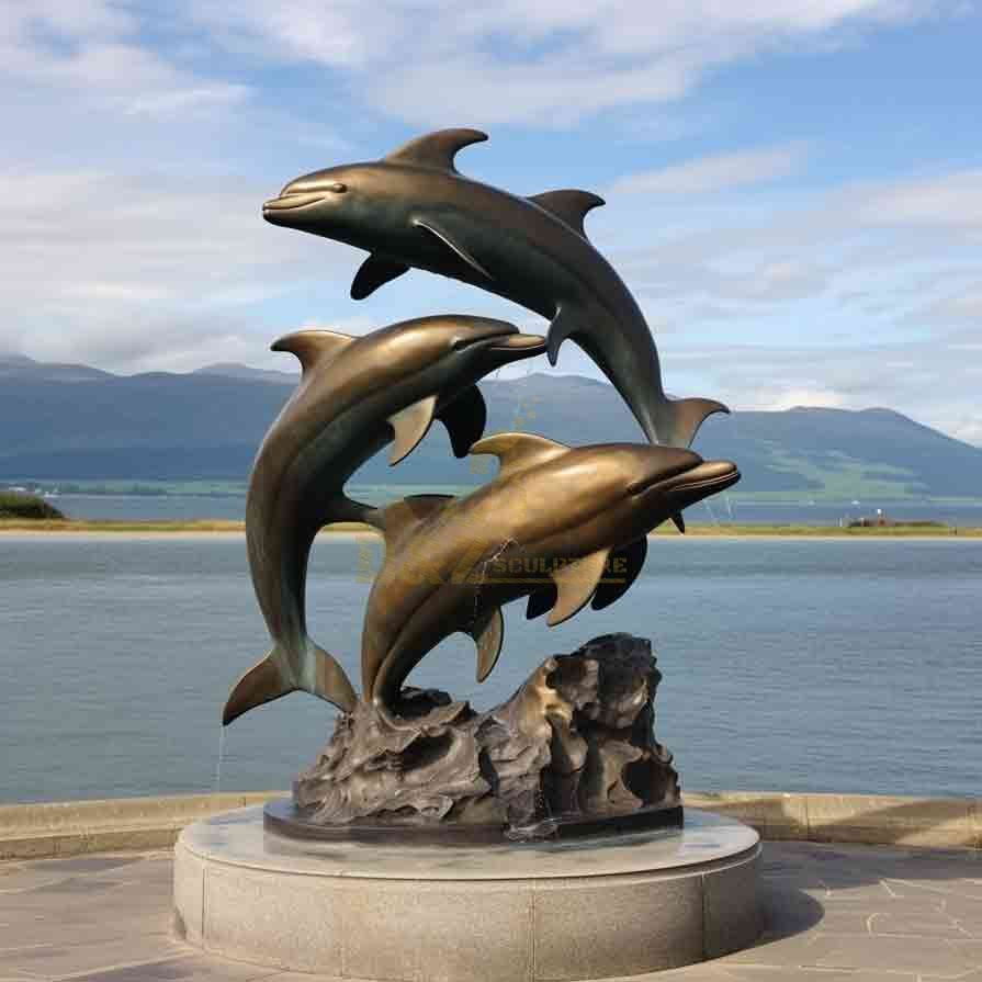 Three bronze dolphins leaping out of the water