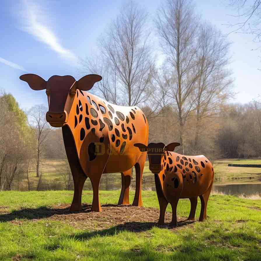 Large cow sculpture family on the grass