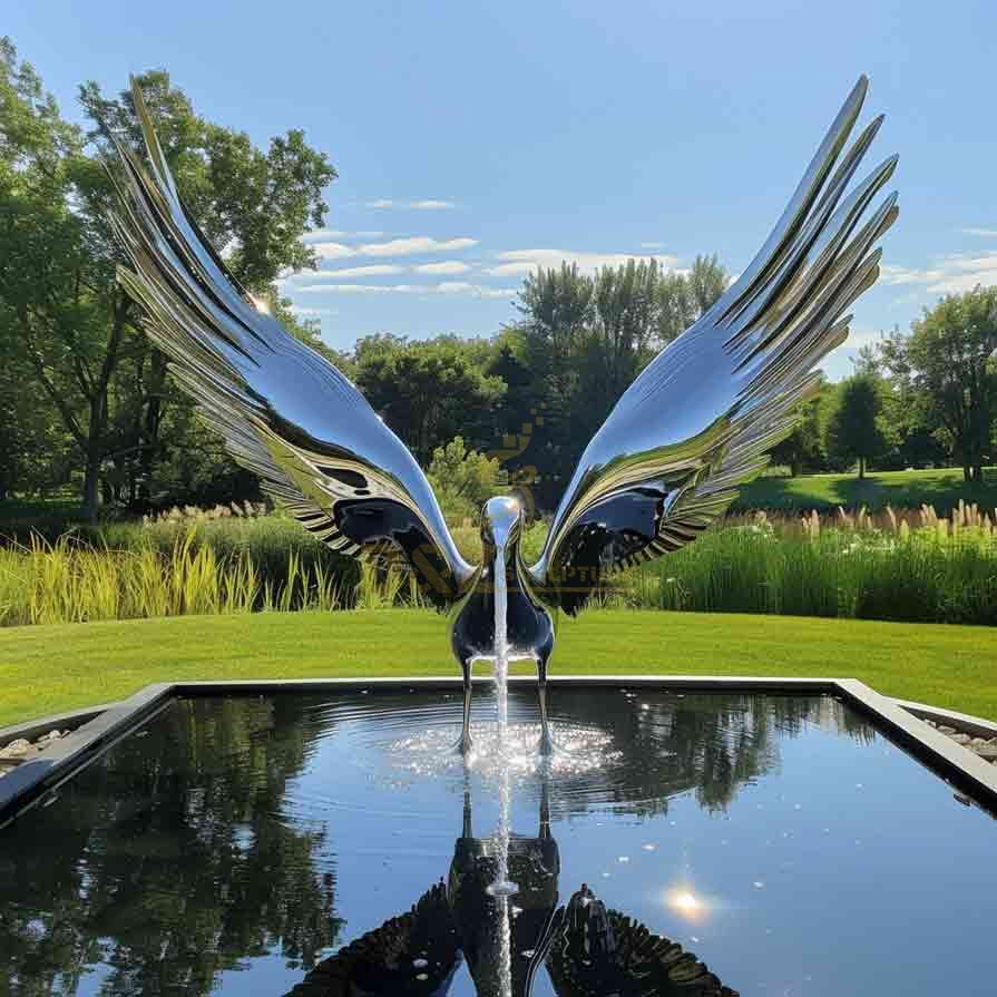 Mirrored stainless steel abstract bird fountain sculpture by the pool