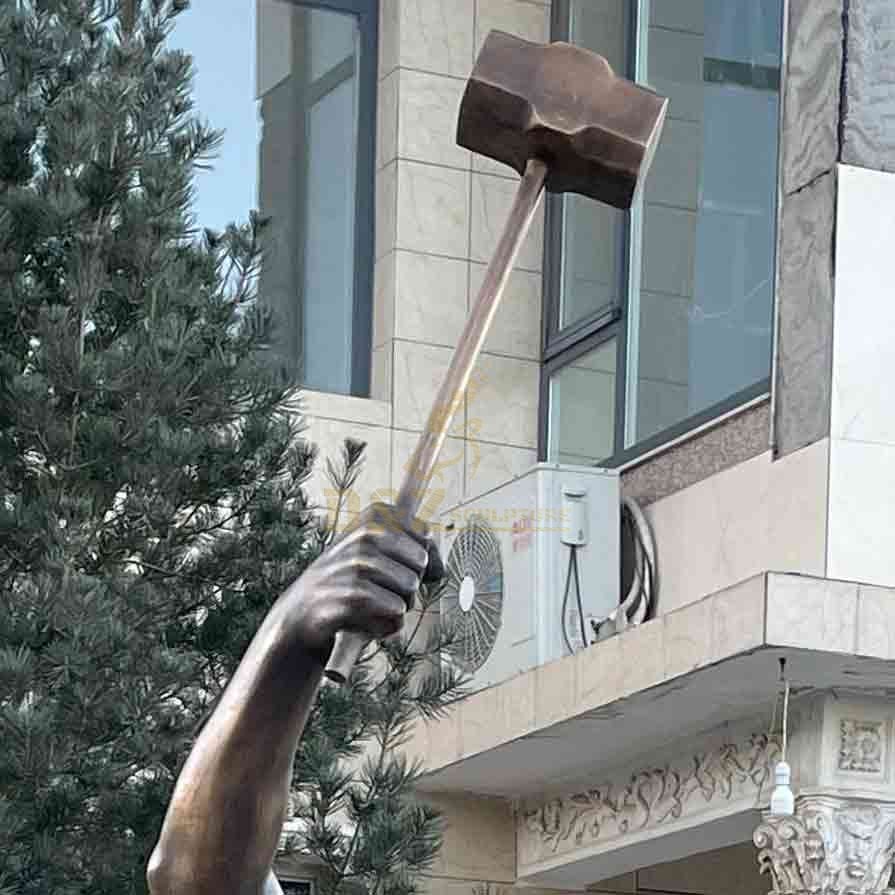 Bronze hammer of self made man statue