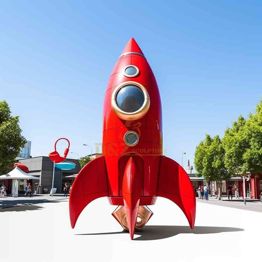 Red cartoon metal rocket sculpture