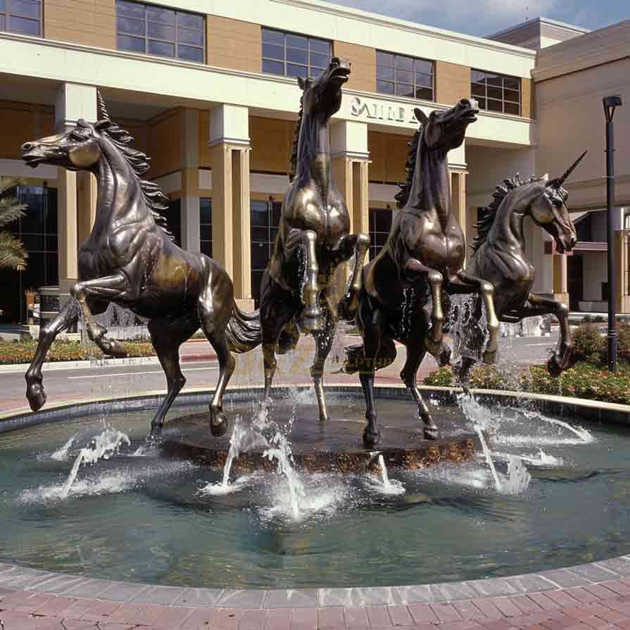 Bronze horse fountain sculpture standing on hind legs, in front of corporate office building