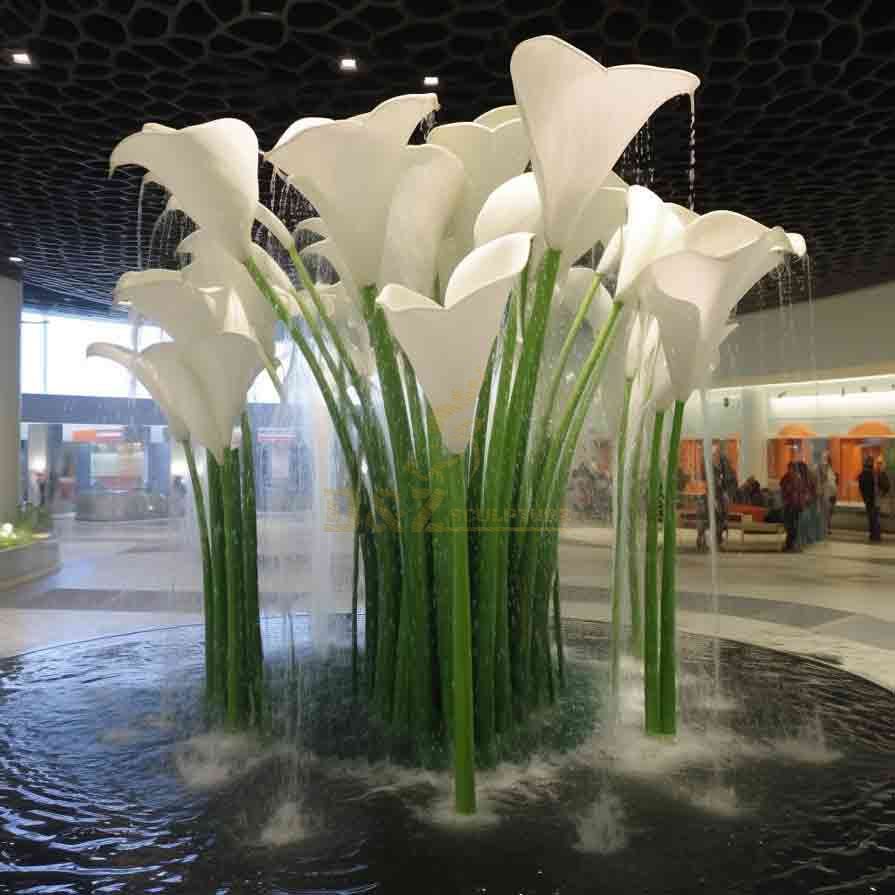 An elegant large metal Calla Lily water fountain sculpture in a business lobby